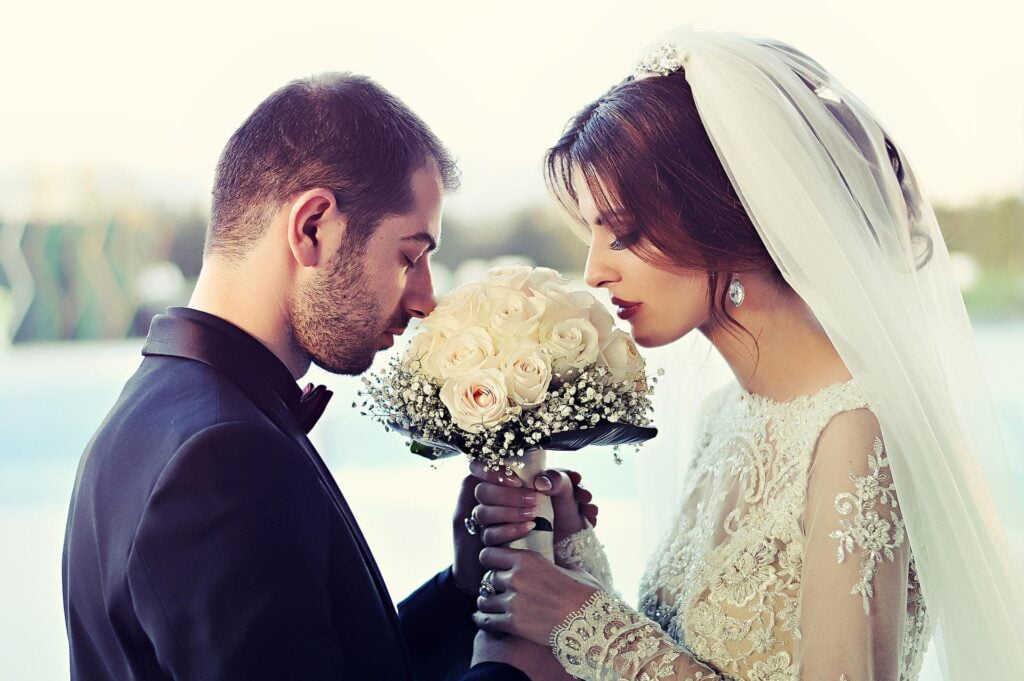 Un mariage entre un homme et une femme sentant l'énergie fondamentale d'amour à travers leur bouquet de fleurs.